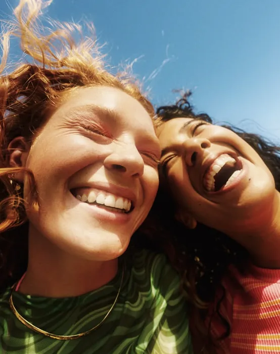Two women laughing in the sun