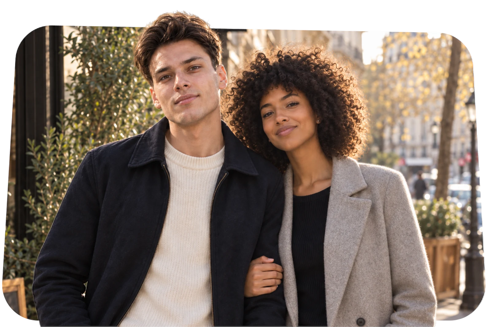 A couple who met on Rivet, arm in arm on a city street